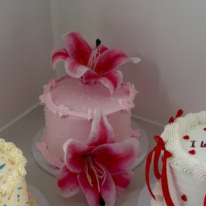 Pale pink cake decorated with a pink lily
